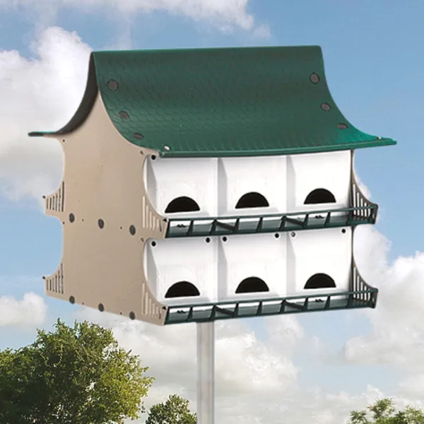Multi-level birdhouse against cloudy sky background.